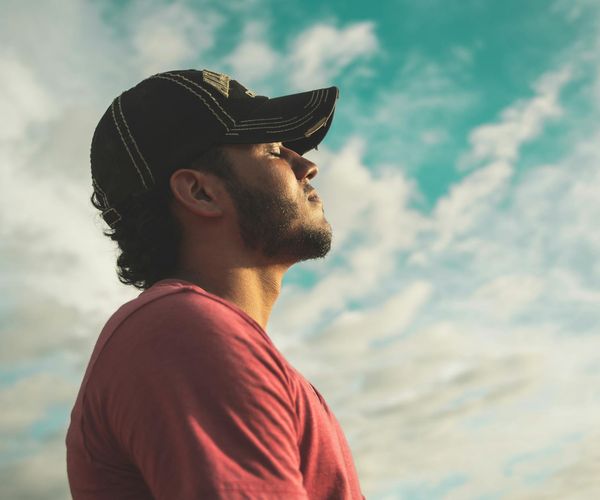 Person meditating peacefully outdoors, symbolizing renewed energy and mental clarity.